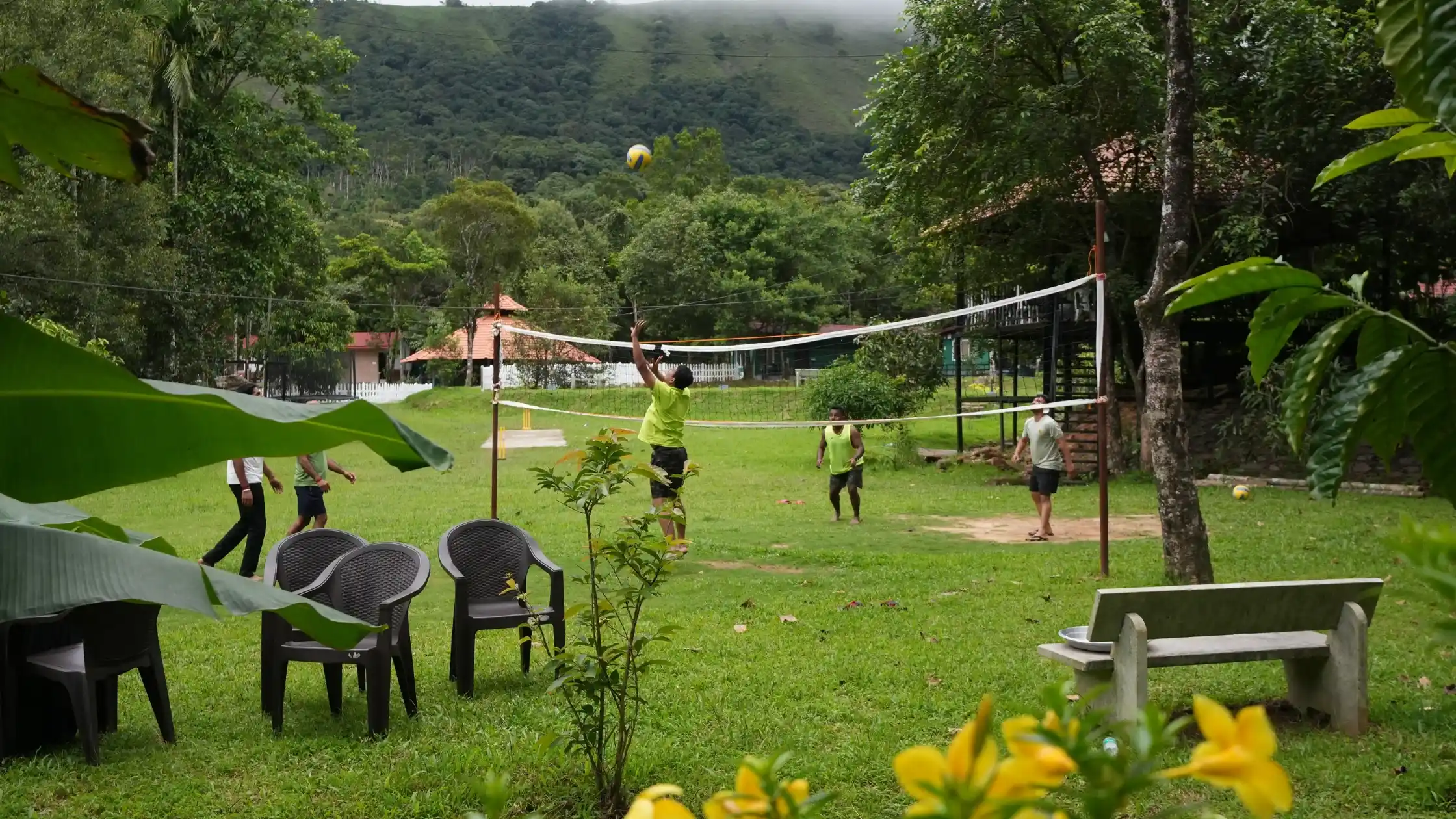 Corporate party in Sakleshpur with colleagues enjoying volleyball at a resort.